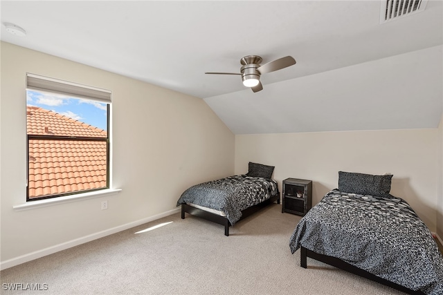 carpeted bedroom featuring lofted ceiling and ceiling fan