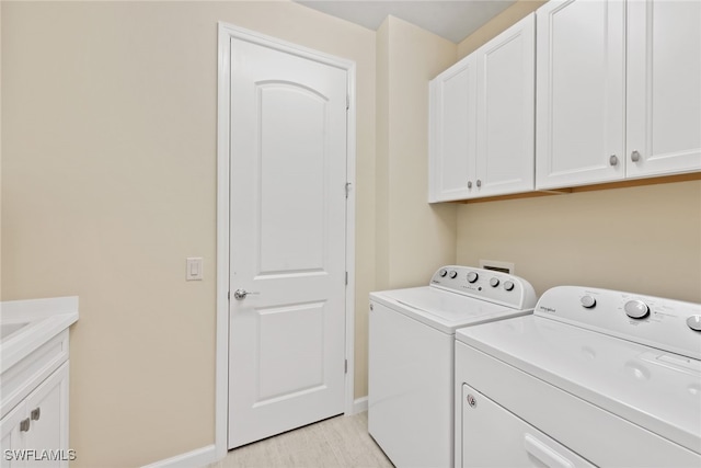 laundry room featuring cabinets and independent washer and dryer