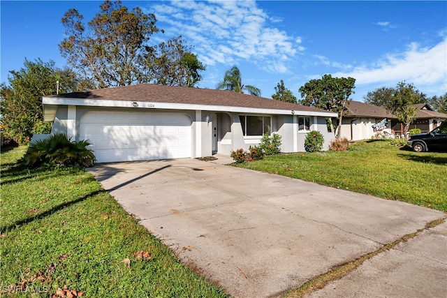 ranch-style home with a front lawn and a garage