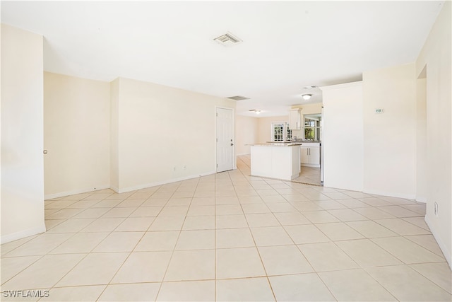 unfurnished living room with light tile patterned floors