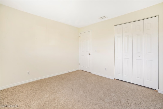 unfurnished bedroom featuring a closet and carpet