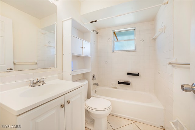 full bathroom featuring vanity, tile patterned floors, toilet, and tiled shower / bath