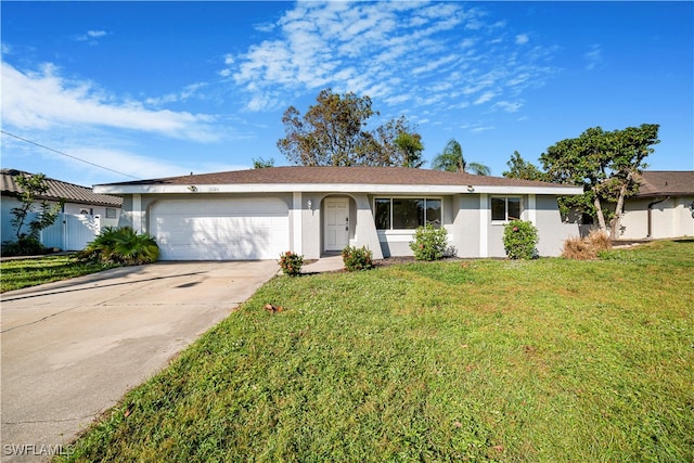 ranch-style house featuring a front lawn and a garage