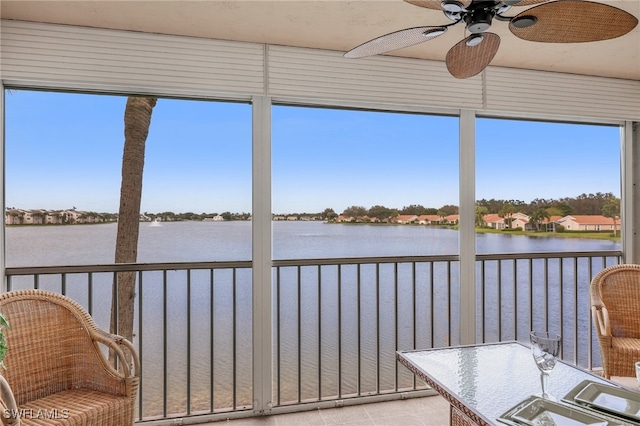 sunroom featuring a water view, a healthy amount of sunlight, and ceiling fan