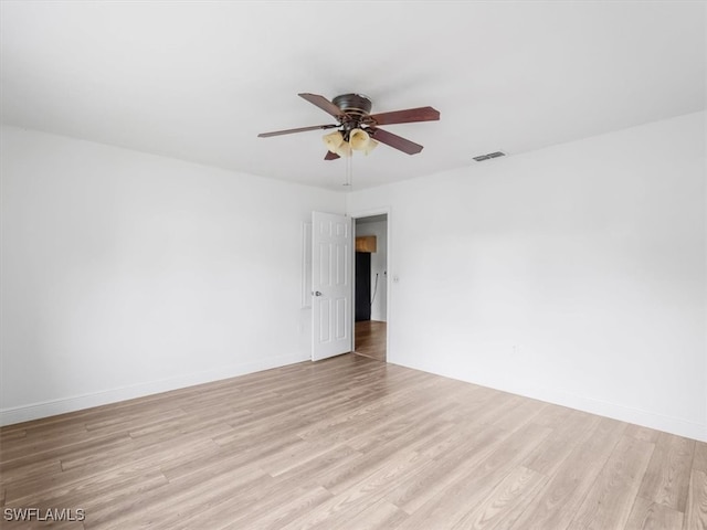 spare room with ceiling fan and light wood-type flooring