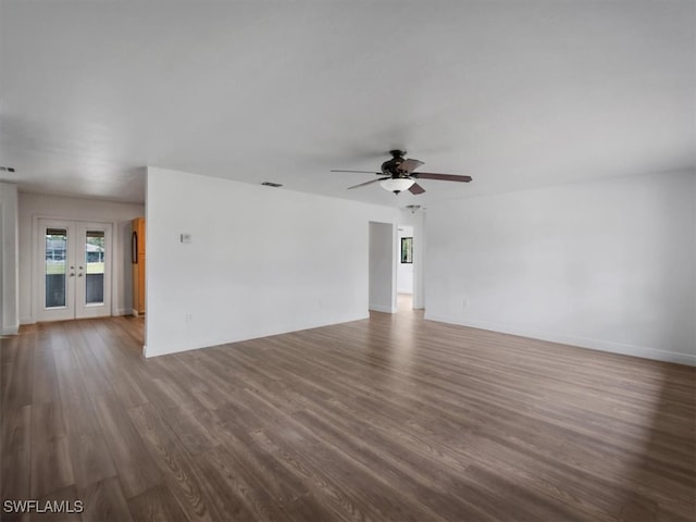 unfurnished living room with french doors, dark hardwood / wood-style flooring, and ceiling fan