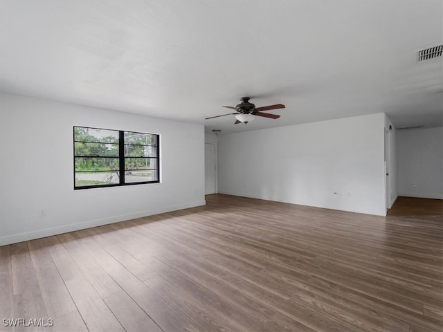 unfurnished room with hardwood / wood-style floors and ceiling fan