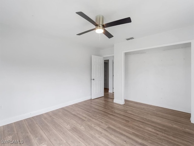 empty room with light hardwood / wood-style flooring and ceiling fan