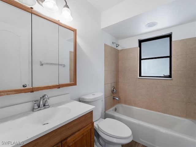 full bathroom featuring vanity, toilet, and tiled shower / bath