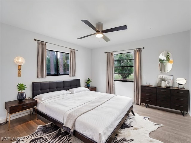 bedroom with ceiling fan and light hardwood / wood-style floors