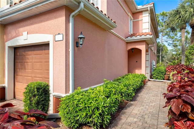 view of exterior entry with a garage