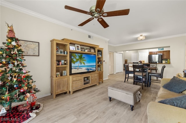 living room featuring crown molding, ceiling fan, and light hardwood / wood-style floors