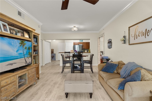 living room featuring crown molding, ceiling fan, and light hardwood / wood-style floors