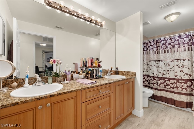 bathroom featuring vanity, toilet, and hardwood / wood-style floors