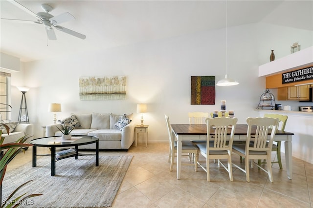 tiled dining space with vaulted ceiling and ceiling fan