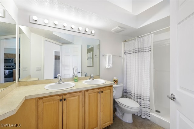 bathroom with vanity, tile patterned floors, toilet, and curtained shower