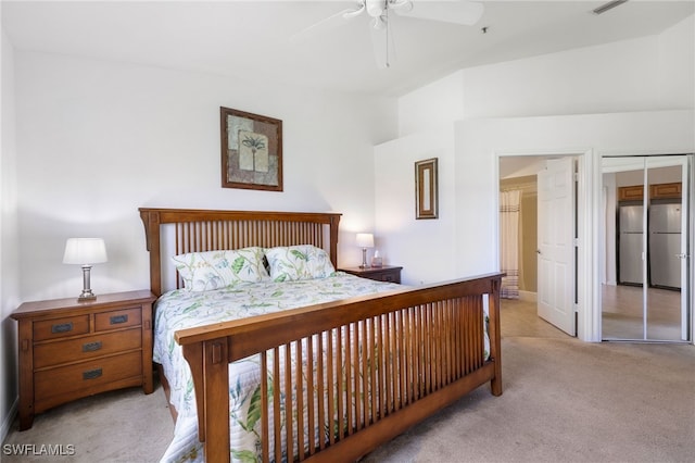 bedroom featuring stainless steel refrigerator, ceiling fan, and light colored carpet