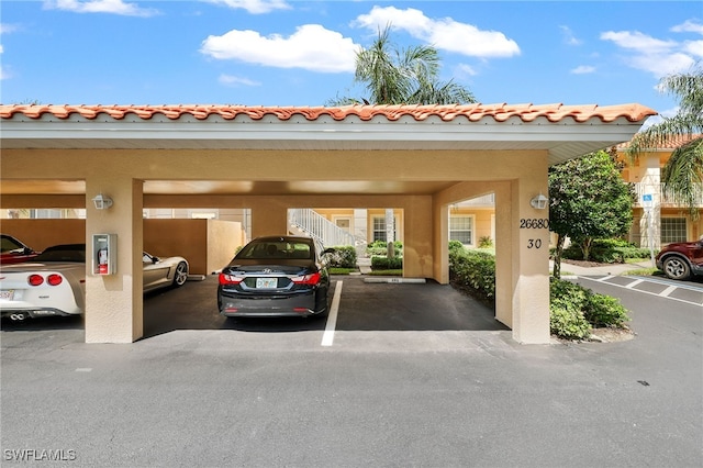 view of vehicle parking featuring a carport