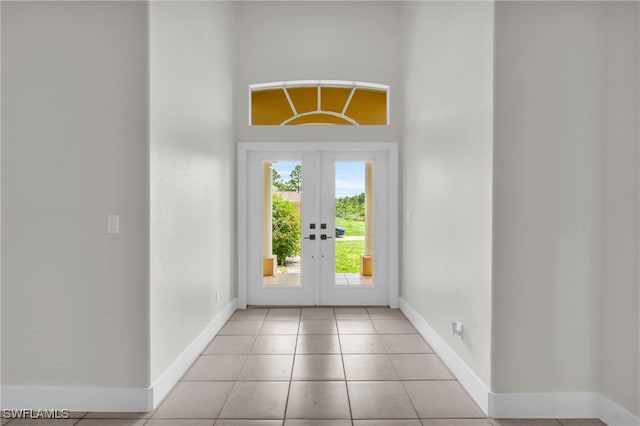 doorway with french doors and light tile patterned floors