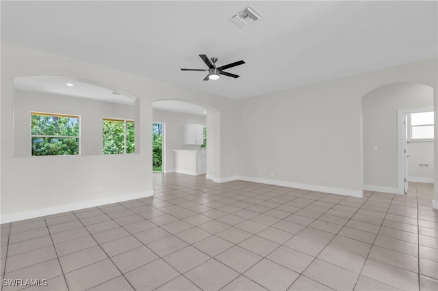 spare room with light tile patterned floors and ceiling fan