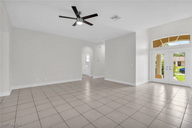 unfurnished room featuring light tile patterned floors, ceiling fan, and french doors