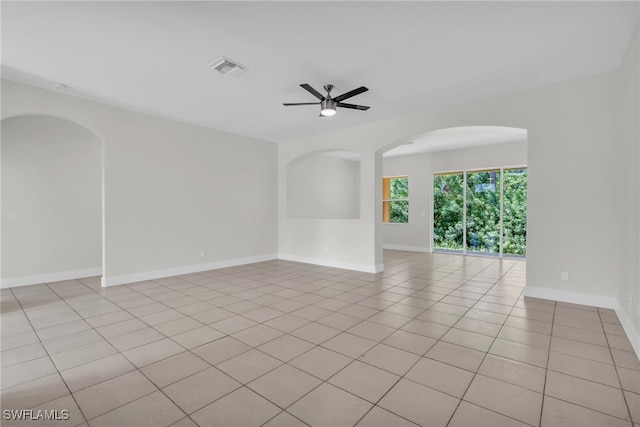 unfurnished room with ceiling fan and light tile patterned floors