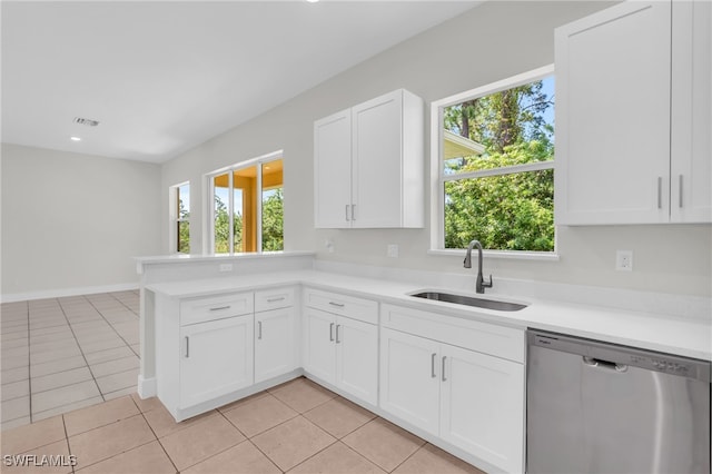 kitchen with dishwasher, sink, white cabinetry, and a wealth of natural light