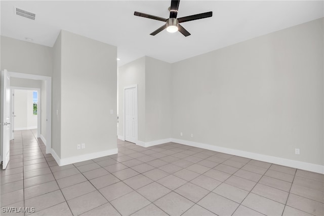 unfurnished room with ceiling fan and light tile patterned floors