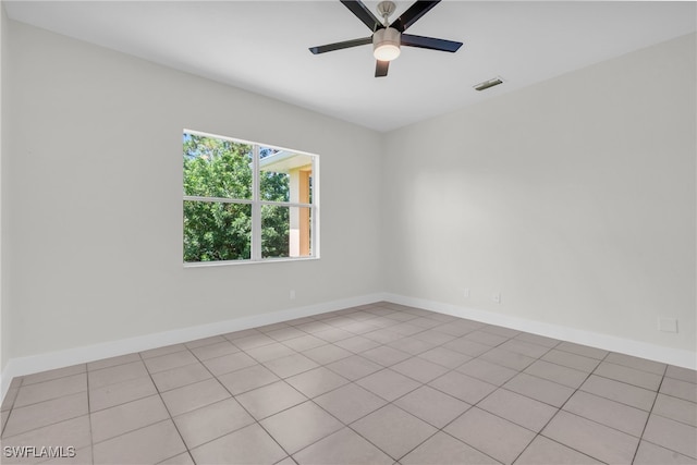 spare room with ceiling fan and light tile patterned floors