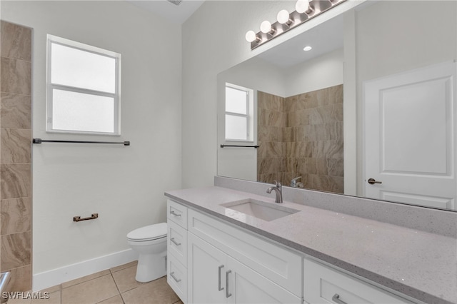 bathroom featuring tile patterned flooring, vanity, and toilet