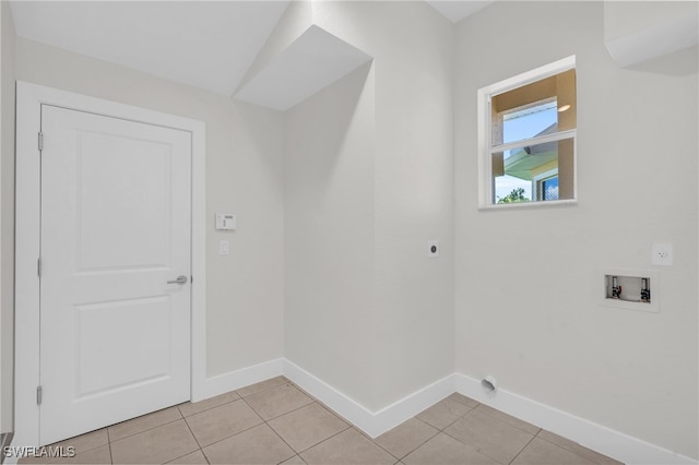 washroom with washer hookup, hookup for an electric dryer, and light tile patterned flooring