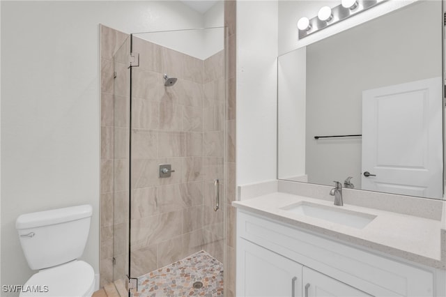 bathroom featuring vanity, toilet, and an enclosed shower