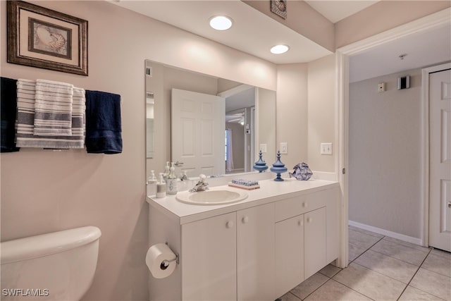 bathroom featuring toilet, vanity, and tile patterned floors