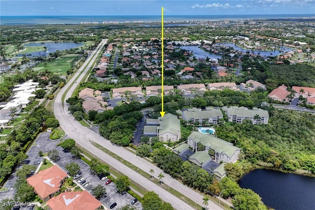 birds eye view of property with a water view