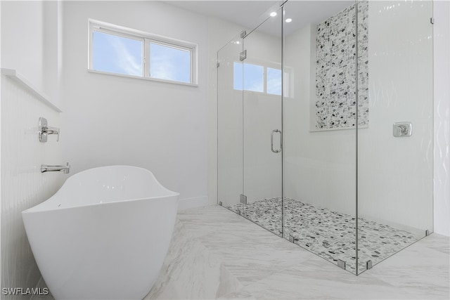 bathroom with separate shower and tub