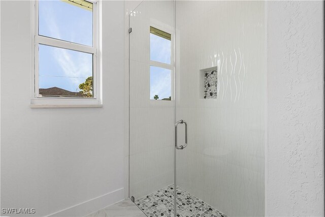 216 Chiquita Blvd N, Cape Coral, FL 33993 - bathroom featuring a shower stall, baseboards, and marble finish flooring
