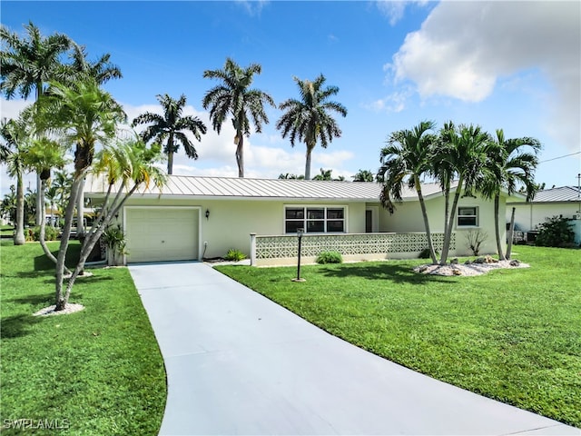 single story home with a front yard and a garage