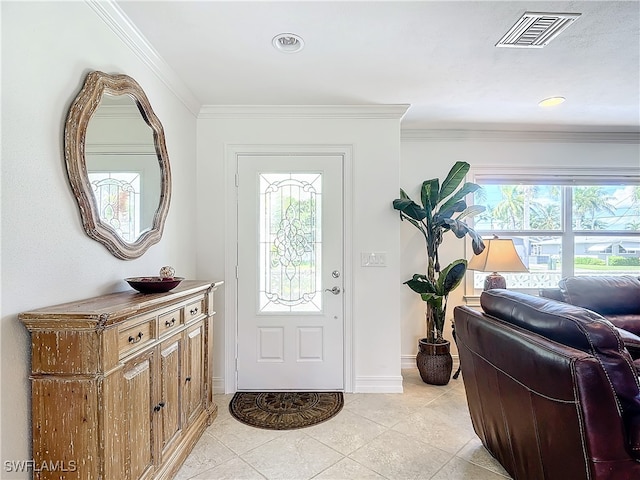 foyer with ornamental molding, light tile patterned floors, and plenty of natural light