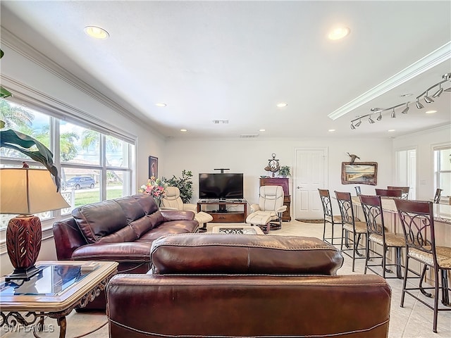 living room featuring ornamental molding and light tile patterned floors