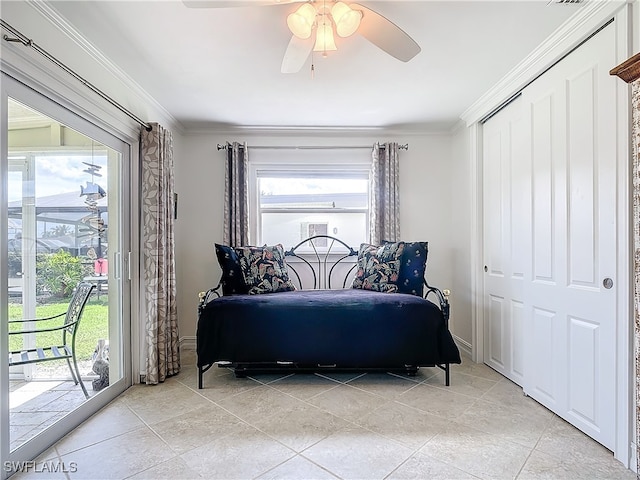 bedroom with multiple windows, access to outside, ceiling fan, and a closet