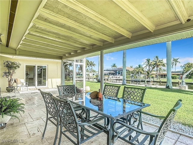 sunroom featuring beam ceiling