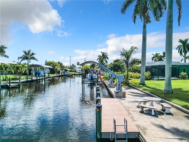 dock area with a yard and a water view