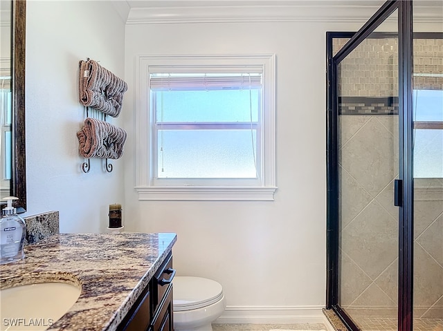 bathroom with ornamental molding, vanity, toilet, and a shower with door