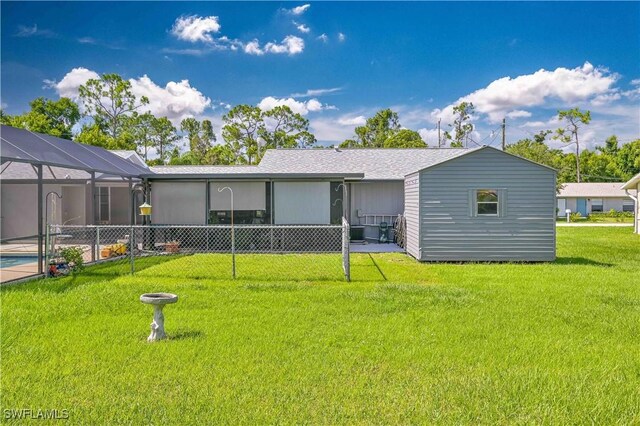 4417/4421 Ruthann Ct, North Fort Myers, FL 33917 - back of house featuring a yard, glass enclosure, and cooling unit
