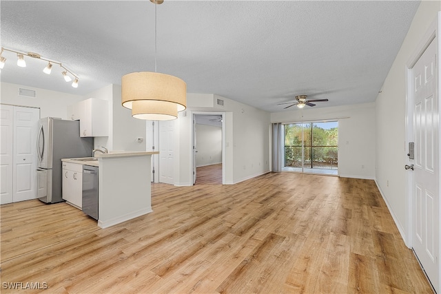 kitchen with stainless steel appliances, hanging light fixtures, a textured ceiling, ceiling fan, and light hardwood / wood-style flooring