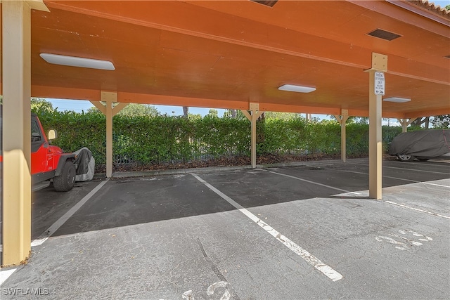 view of parking / parking lot with a carport