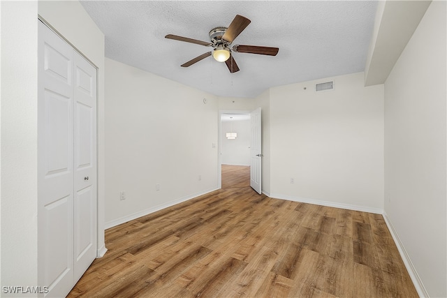 interior space with light hardwood / wood-style floors, a closet, and a textured ceiling