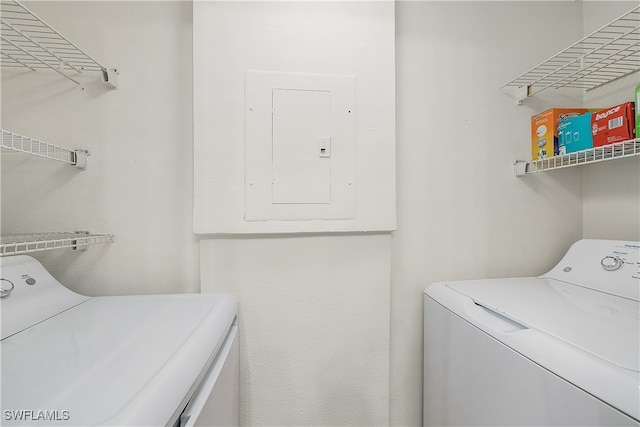 washroom with electric panel and independent washer and dryer