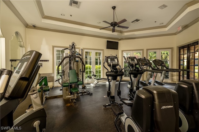 exercise room featuring ceiling fan, crown molding, french doors, and a raised ceiling