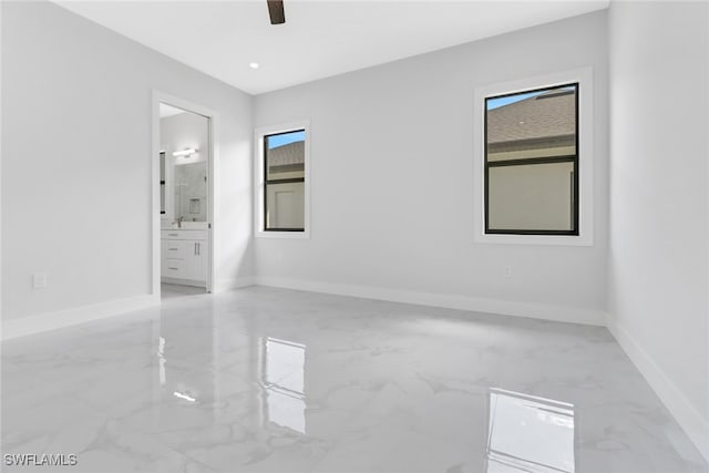 spare room featuring ceiling fan and plenty of natural light